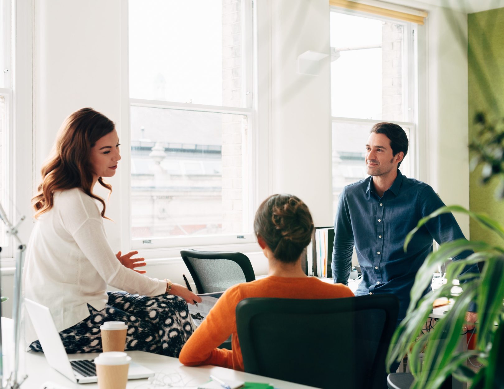 Group of employees discussing something in an office setting