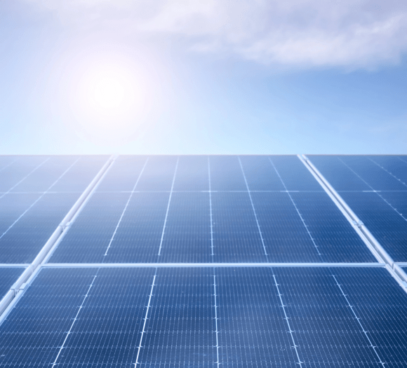 view of a solar panel with sunny sky peering over the top.