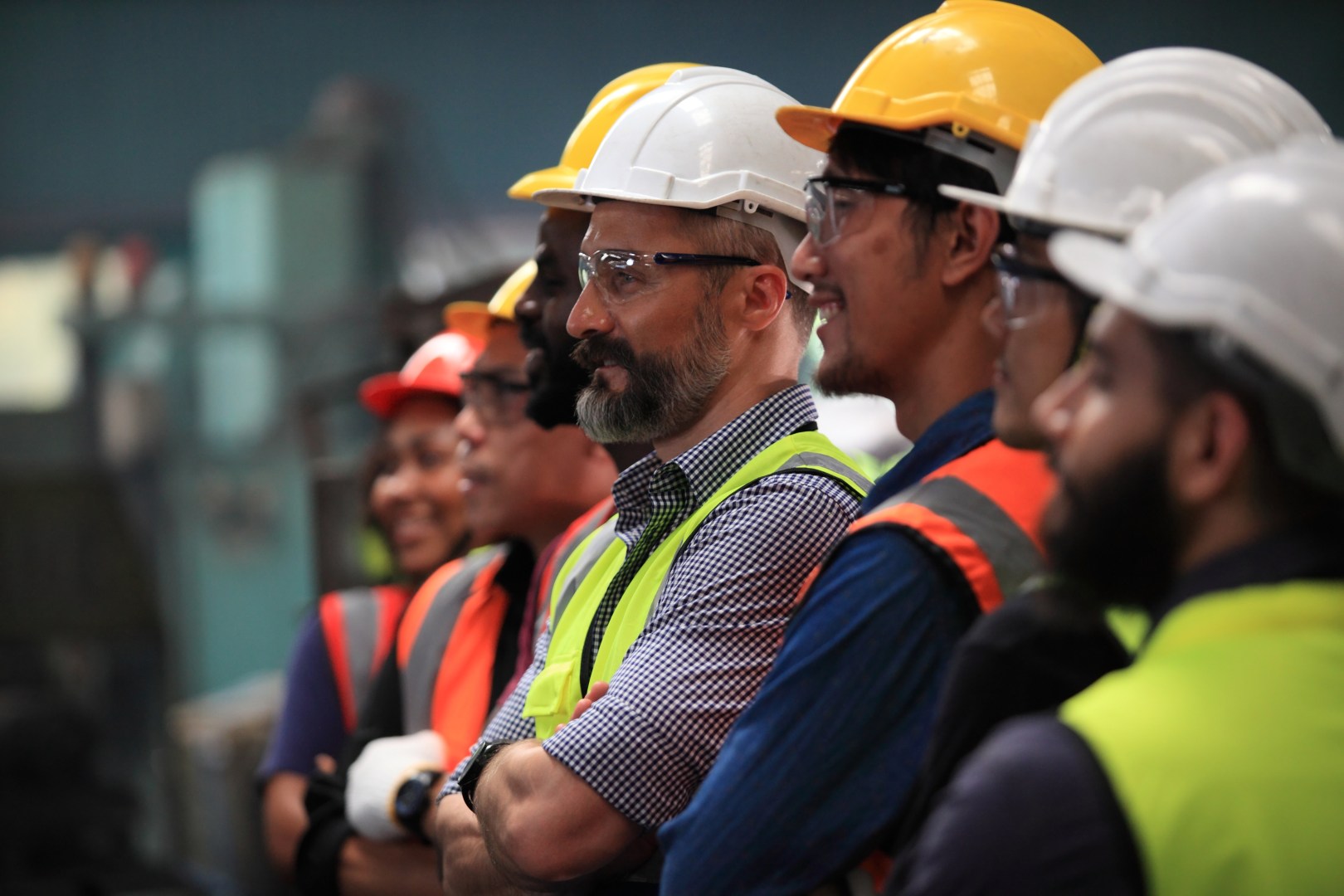 Manufacturing workers in safety gear.