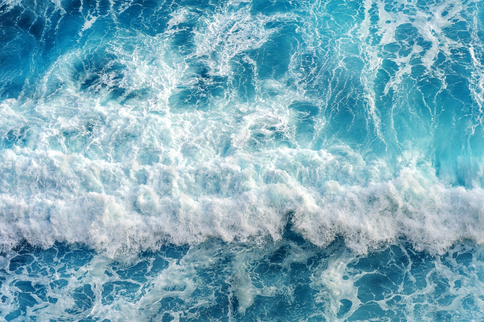 A view of the ocean, showing waves crashing.