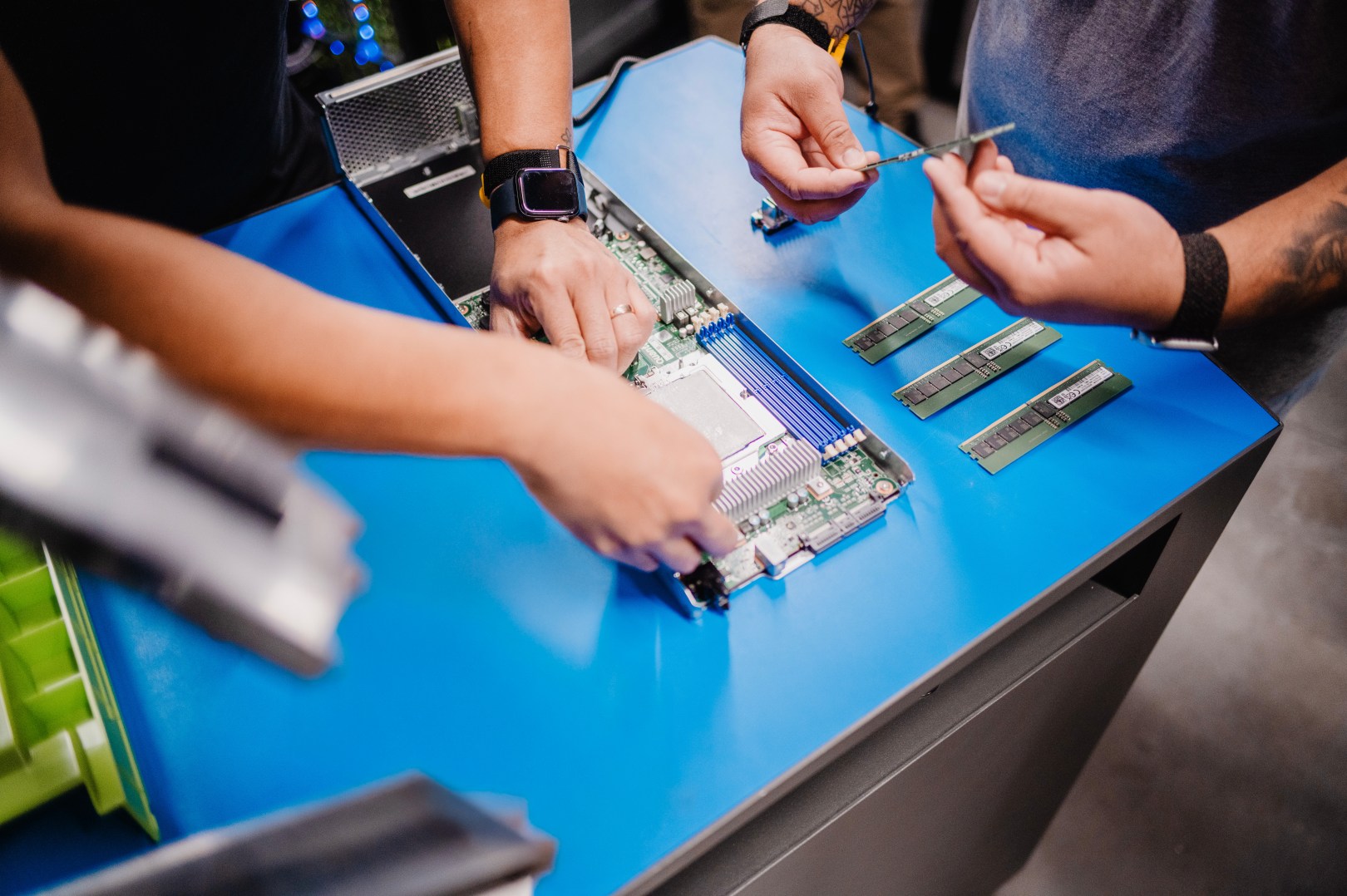 Image of two people's hands working together in a technical setting
